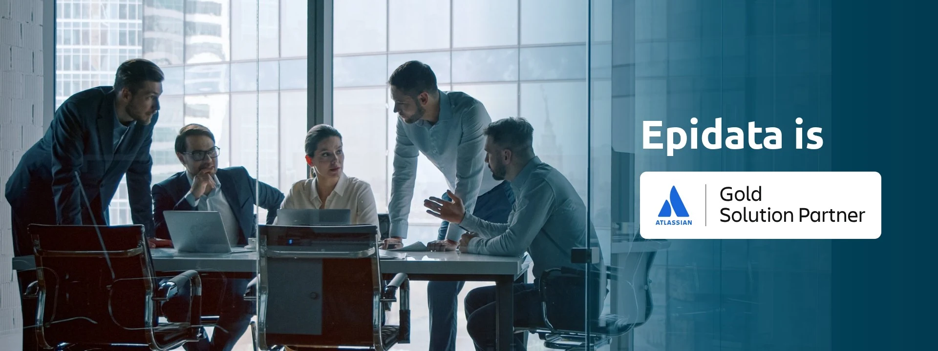 Team meeting in a glass-walled room next to the Atlassian Gold Solution Partner badge